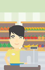 Image showing Cashier standing at the checkout in supermarket.