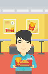 Image showing Man with tray full of fast food.