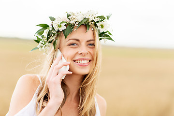 Image showing happy young woman calling on smartphone at country