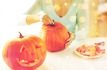 Image showing close up of woman with pumpkins at home