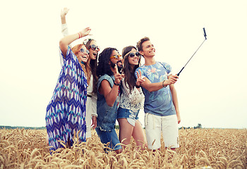 Image showing hippie friends with smartphone on selfie stick