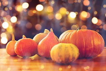 Image showing close up of halloween pumpkins on wooden table