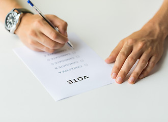 Image showing close up of hands with vote or ballot on election