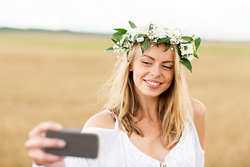 Image showing happy young woman taking selfie by smartphone