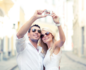 Image showing travelling couple taking photo picture with camera