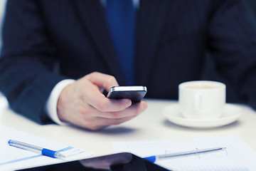 Image showing businessman with smartphone reading news