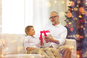 Image showing smiling grandfather and grandson at home