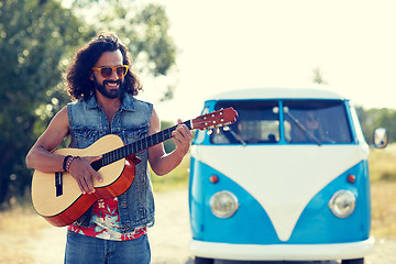 Image showing hippie man playing guitar over minivan car outdoor