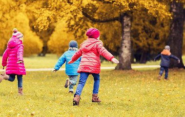 Image showing group of happy little kids running outdoors