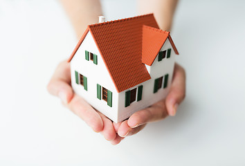 Image showing close up of hands with house model
