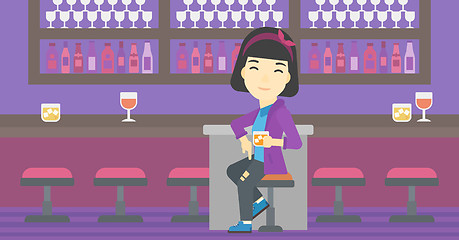 Image showing Woman sitting at the bar counter.