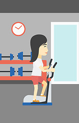 Image showing Woman exercising on elliptical trainer.