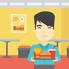 Image showing Man with tray full of fast food.