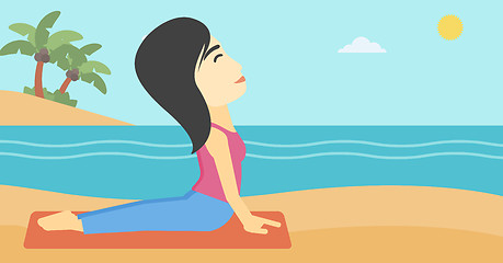 Image showing Woman practicing yoga upward dog pose on beach.