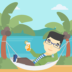 Image showing Man chilling in hammock with cocktail.