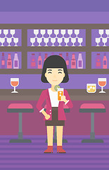 Image showing Woman drinking orange cocktail at the bar.