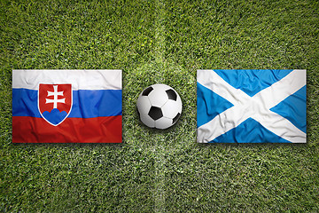 Image showing Slovakia vs. Scotland flags on soccer field