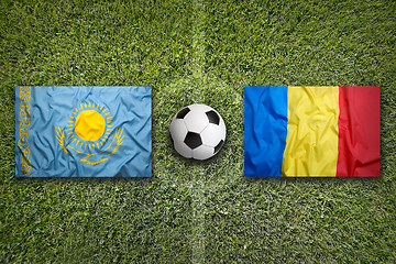 Image showing Kazakhstan vs. Romania flags on soccer field