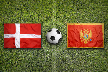 Image showing Denmark vs. Montenegro flags on soccer field