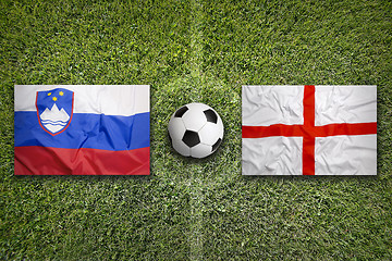 Image showing Slovenia vs. England flags on soccer field