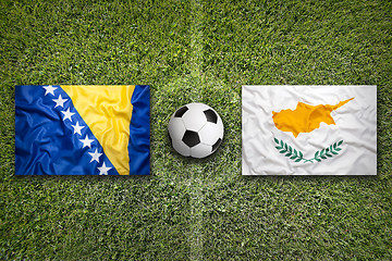 Image showing Bosnia and Herzegovina vs. Cyprus flags on soccer field