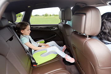 Image showing family with child in safety seat driving car