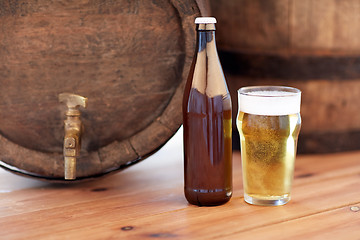 Image showing close up of old beer barrel, glass and bottle