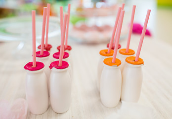 Image showing close up of bottles with drinks and straws