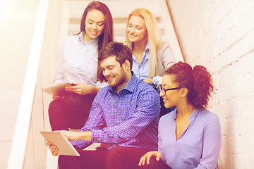 Image showing team with tablet pc computer sitting on staircase