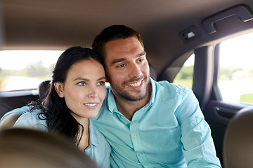 Image showing happy man and woman hugging in car