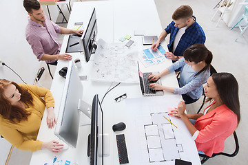 Image showing creative team with computers, blueprint at office