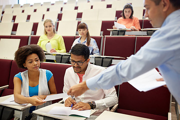 Image showing teacher giving tests to students at lecture