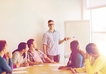 Image showing group of smiling students with flip board