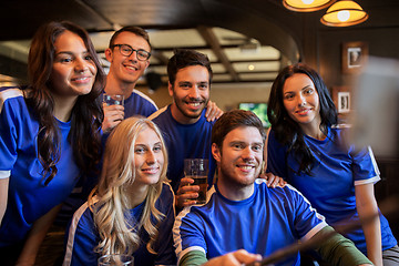 Image showing football fans with beer taking selfie at pub