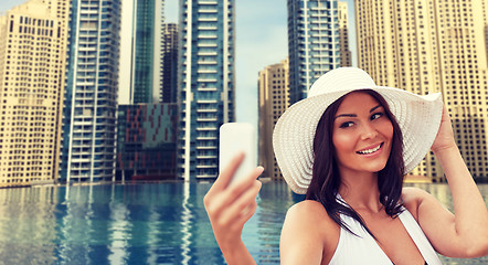 Image showing young woman taking selfie with smartphone