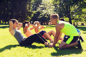 Image showing group of friends or sportsmen exercising outdoors