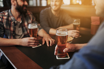 Image showing happy male friends drinking beer at bar or pub