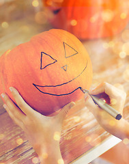 Image showing close up of woman with pumpkins at home