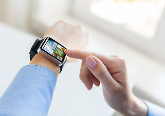 Image showing close up of female hands with news on smart watch