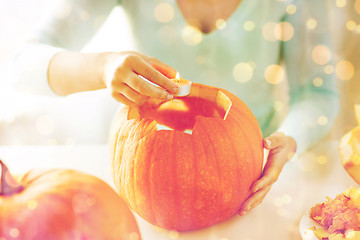 Image showing close up of woman with pumpkins at home