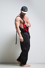 Image showing muscular construction worker in overalls