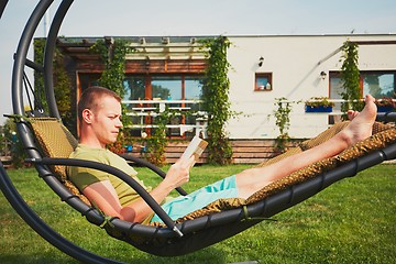 Image showing Man resting in the garden of the house