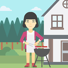 Image showing Woman cooking meat on barbecue grill.