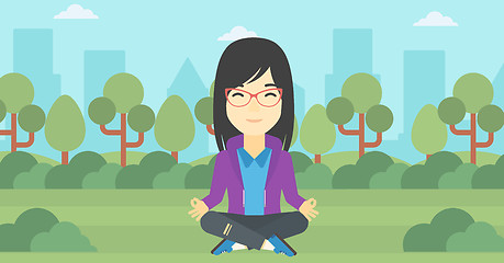 Image showing Business woman meditating in lotus position.