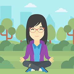 Image showing Business woman meditating in lotus position.