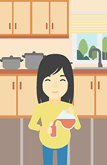 Image showing Pregnant woman pouring juice.