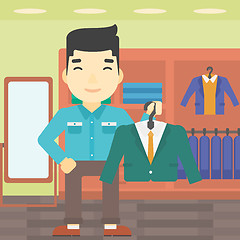 Image showing Man holding suit jacket in clothing store.
