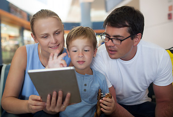 Image showing Parents and son with tablet PC at the airport