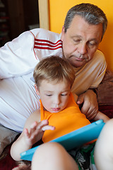 Image showing Grandfather and grandson with touch pad