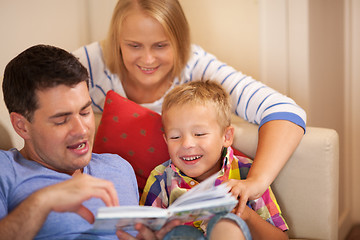 Image showing Family reading book together at home